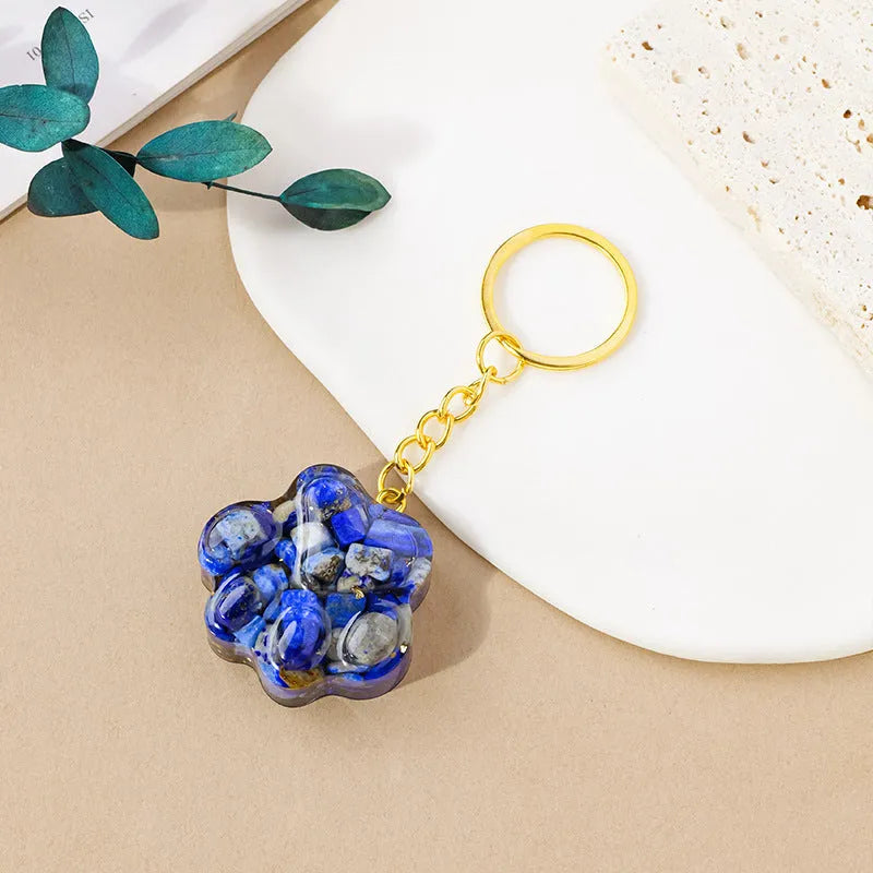 Natural crystal cat's paw keychain pendant in various gemstone colours including pink, red, green and blue variants