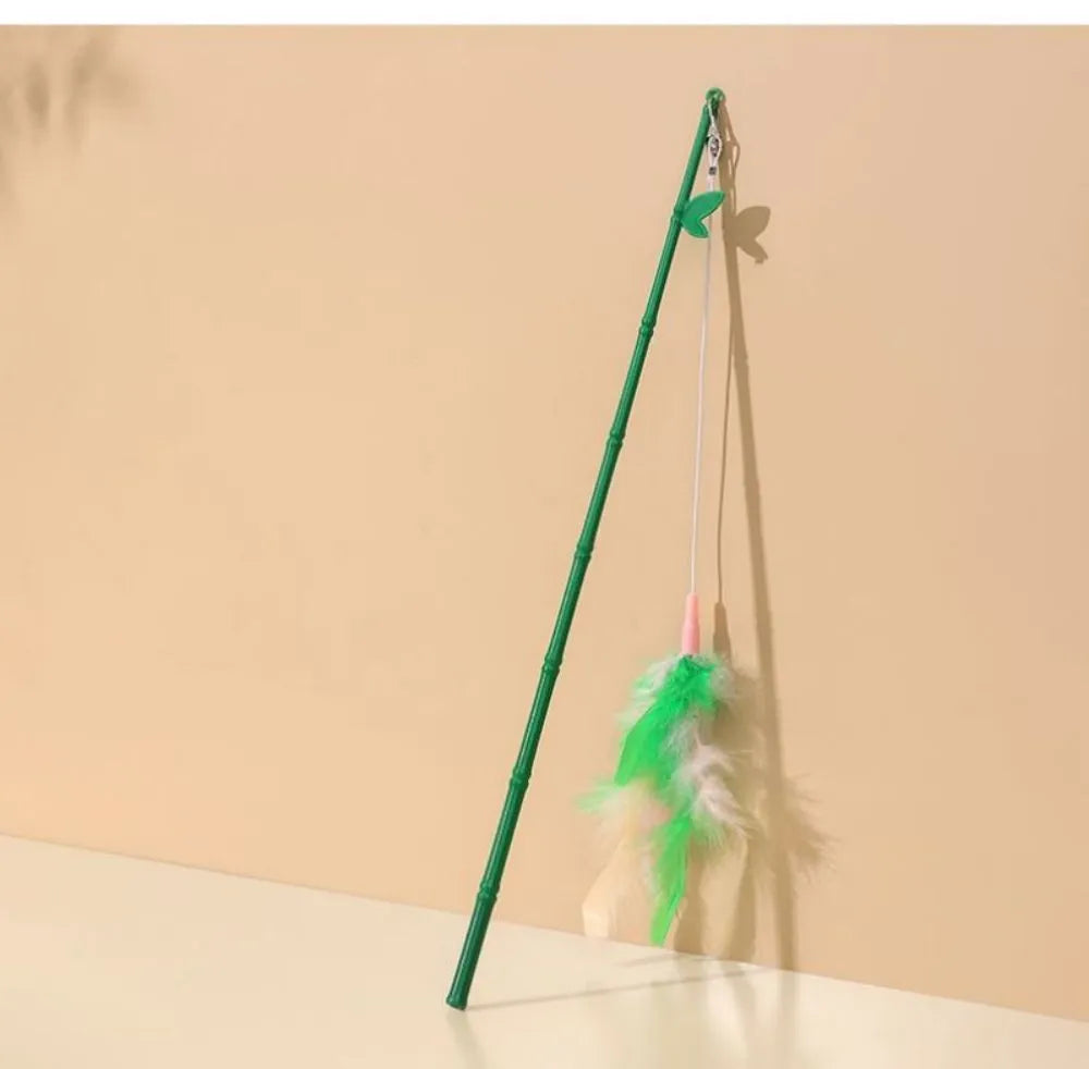 Interactive cat toy feather wand with green bells and feathers on a durable wand