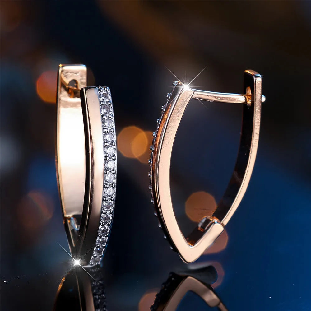 Women's V-shaped geometric copper ear clips in champagne gold with white diamond accents