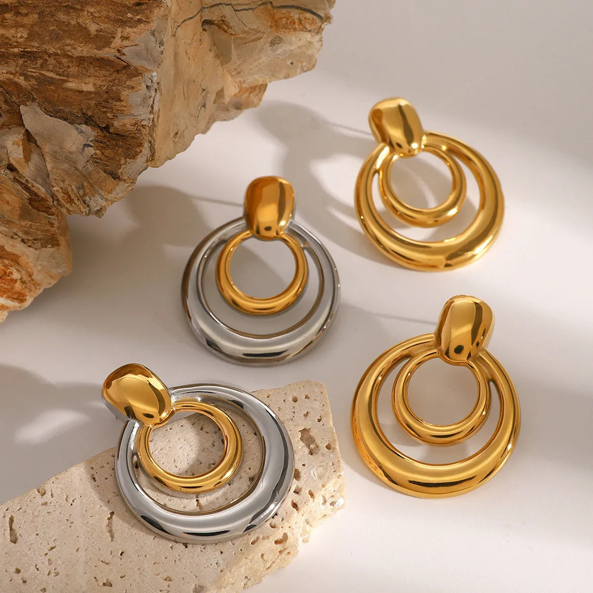 Round double layer hollow stud earrings with electroplated 18K gold finish in golden colour