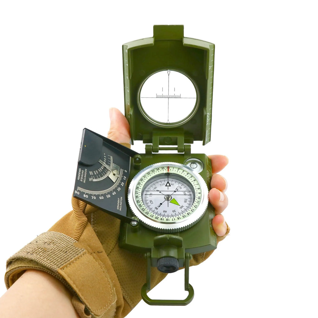 K4074 high-precision outdoor compass with metal body, hanging rope, and ring on a wooden surface