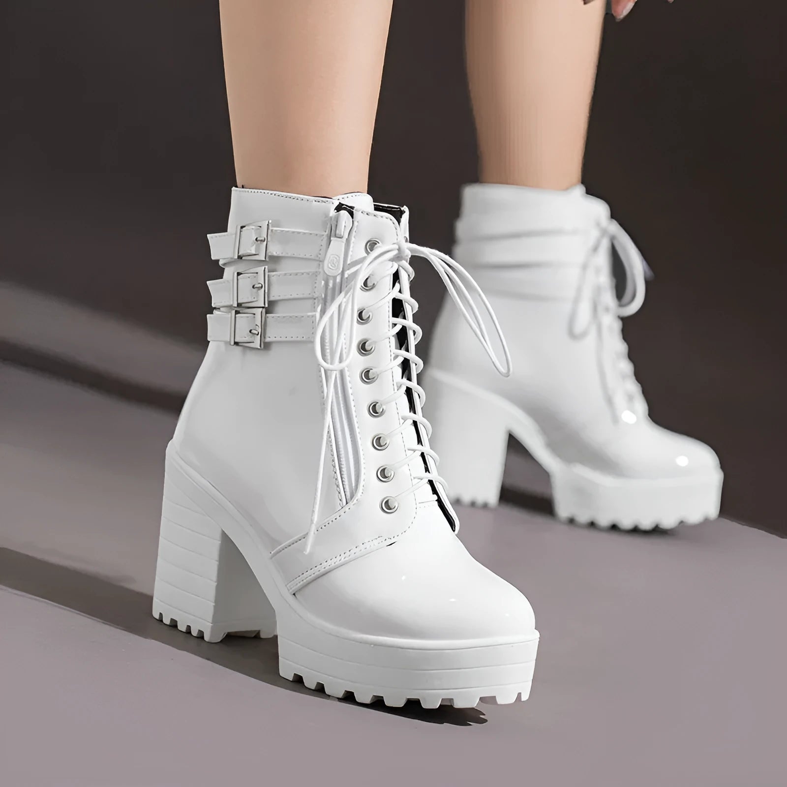 Women's black thick-heeled short boots with lace-up front and round toe, showing waterproof platform detail