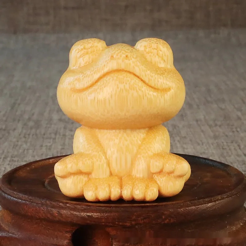 Solid bamboo smiling frog cartoon ornament measuring 5cm tall.