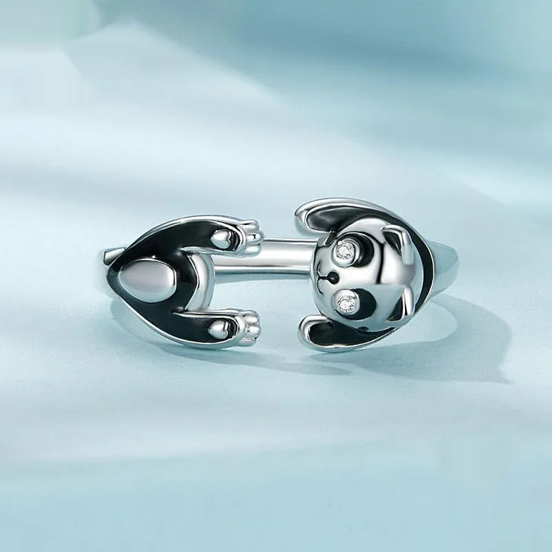 Adjustable sterling silver panda ring bracelet with white gold plating on a wrist.