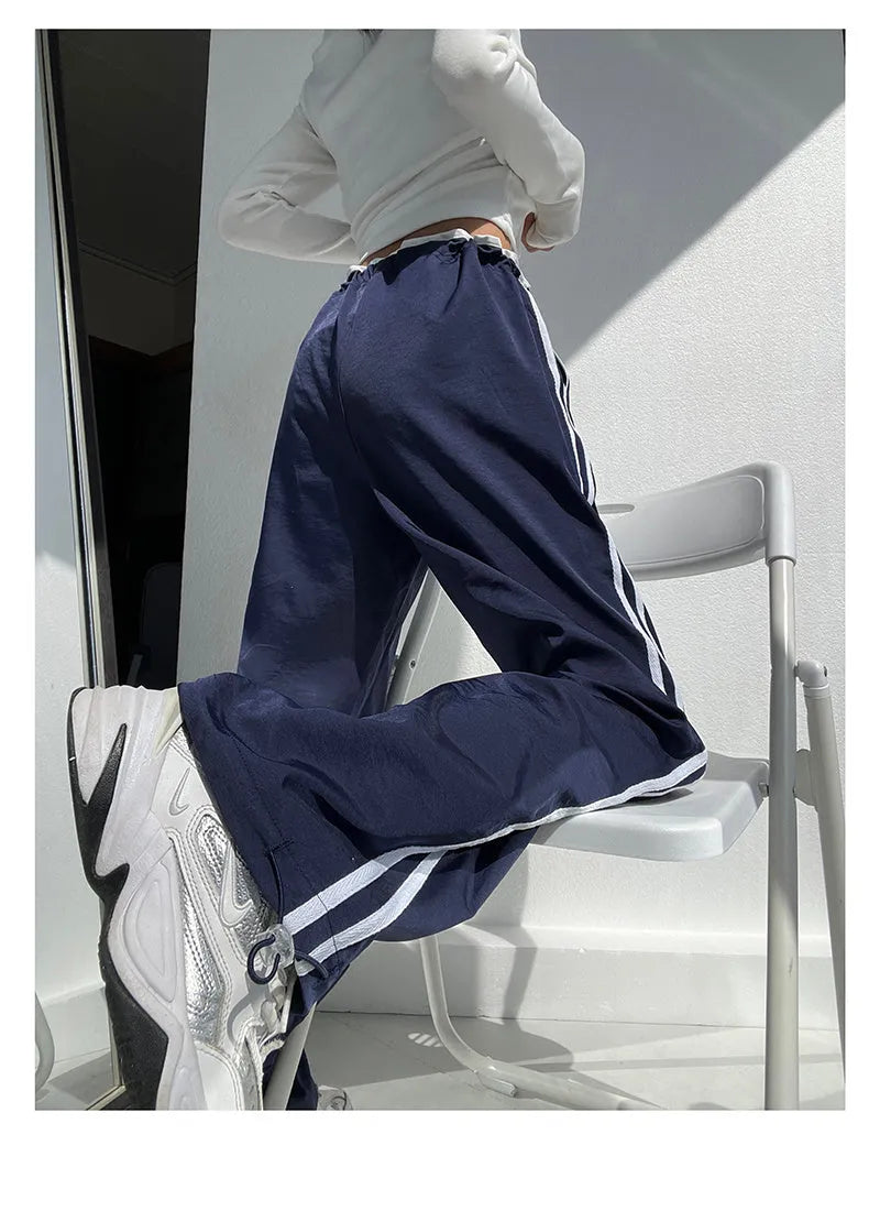 Women's navy blue parallel bars contrast colour loose straight leg trousers on a low waist.