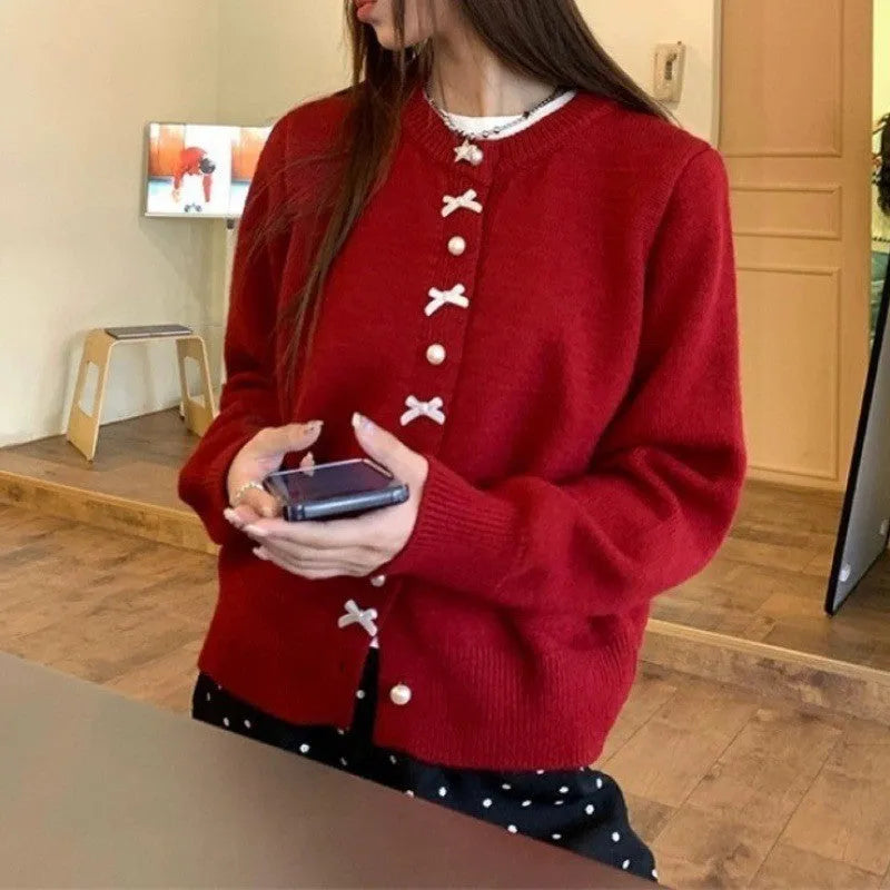 Women's acrylic fibre cardigan with bow detail and pearl buttons in solid colour options