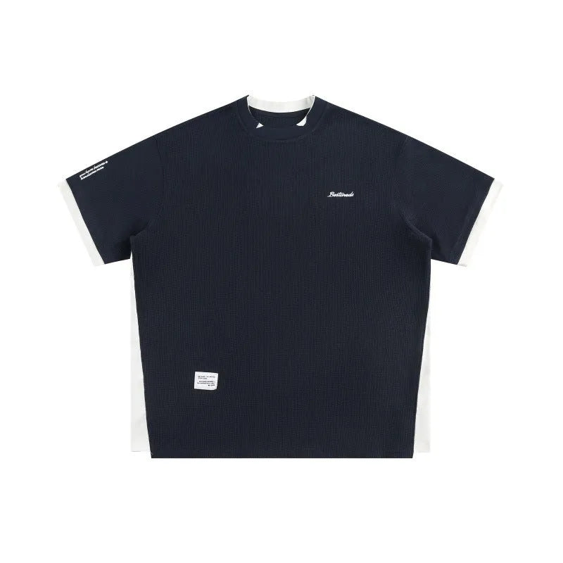 Retro alphabet embroidered loose waffle short-sleeved t-shirt in navy blue on a hanger.