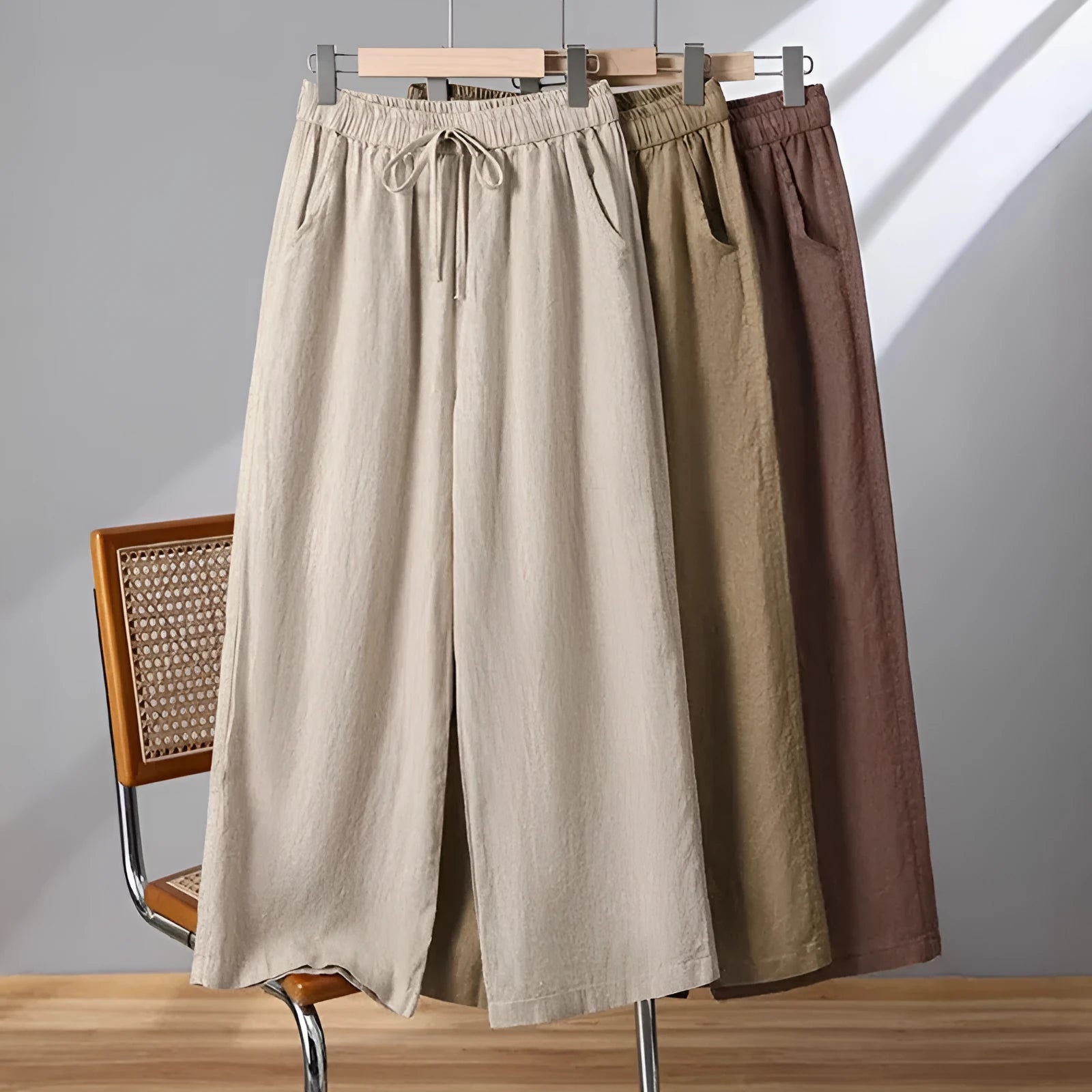 Women's apricot straight-leg casual trousers with a drawstring elastic waistband laid flat.