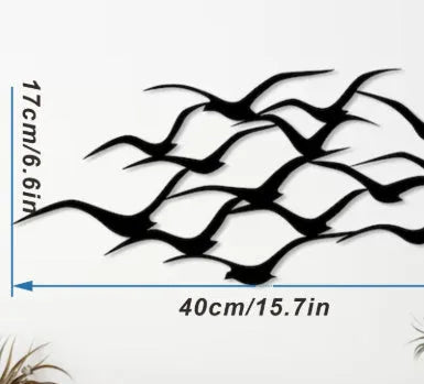 Metal flying bird wall decoration with seagull finish on a white wall