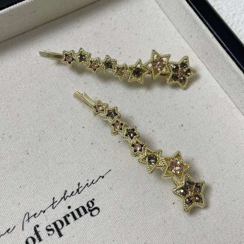 Gold colour alloy hair barrettes with broken clip design and five-pointed star decoration