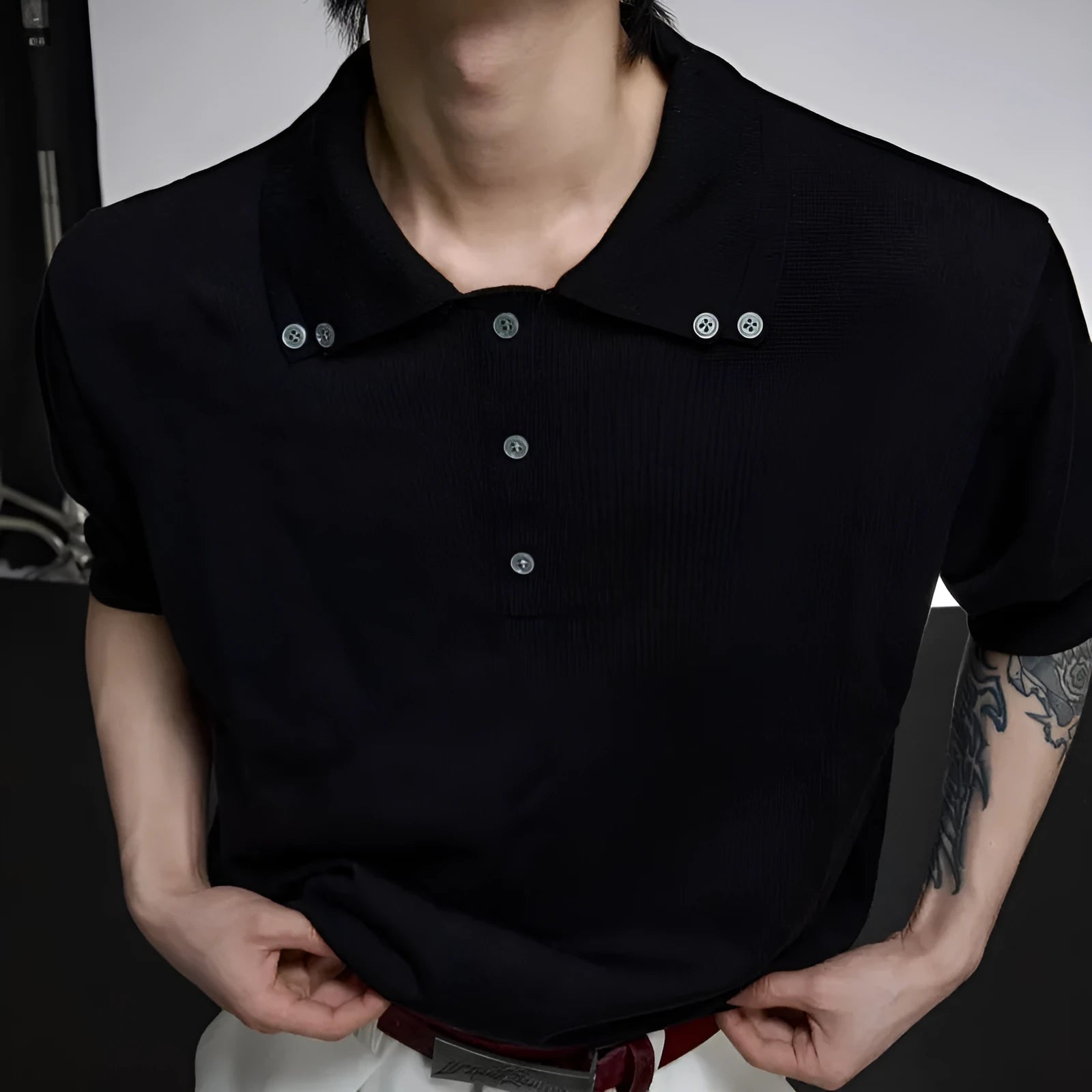 Men's loose fit short sleeve shirt with a lapel collar in grey, hanging on a hanger.