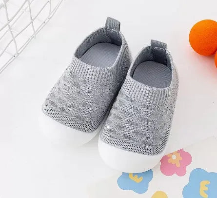Baby soft sole non-slip walking shoes in cream yellow with fly woven cotton upper and natural rubber sole