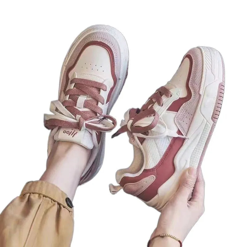 Beige and pink low-top sneaker with a height-increasing rubber sole on a white background