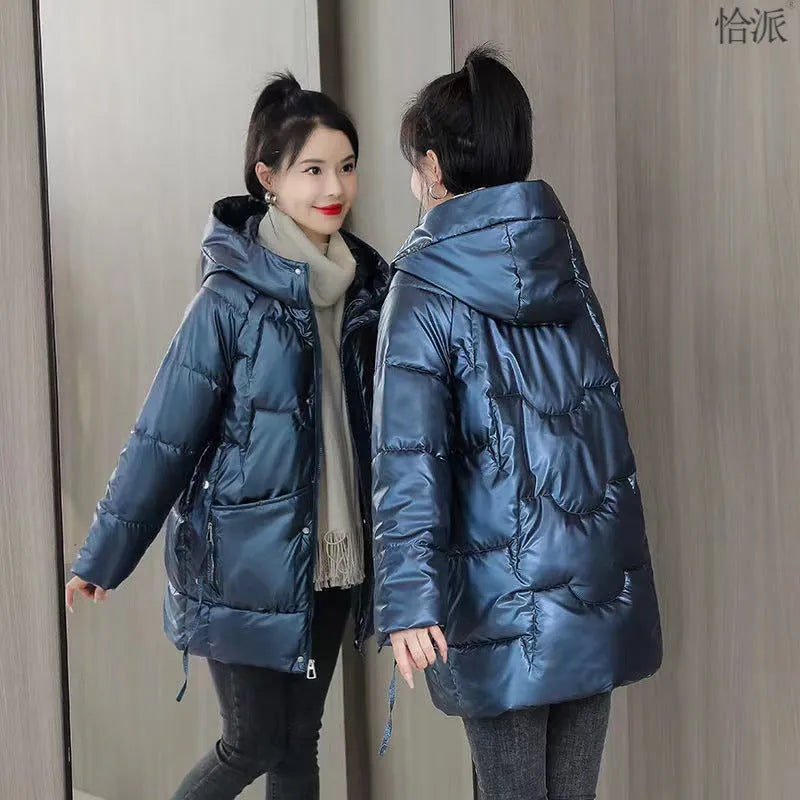 Women's loose fit thick hooded winter jacket in blue, shown on a model.