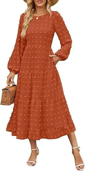 A woman wearing a beige high waist long sleeve dress with ruffle details on a autumn day.