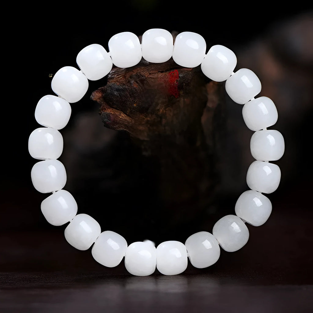White Hetian jade barrel bead bracelet on a wrist, showing three bead size options for men and women.