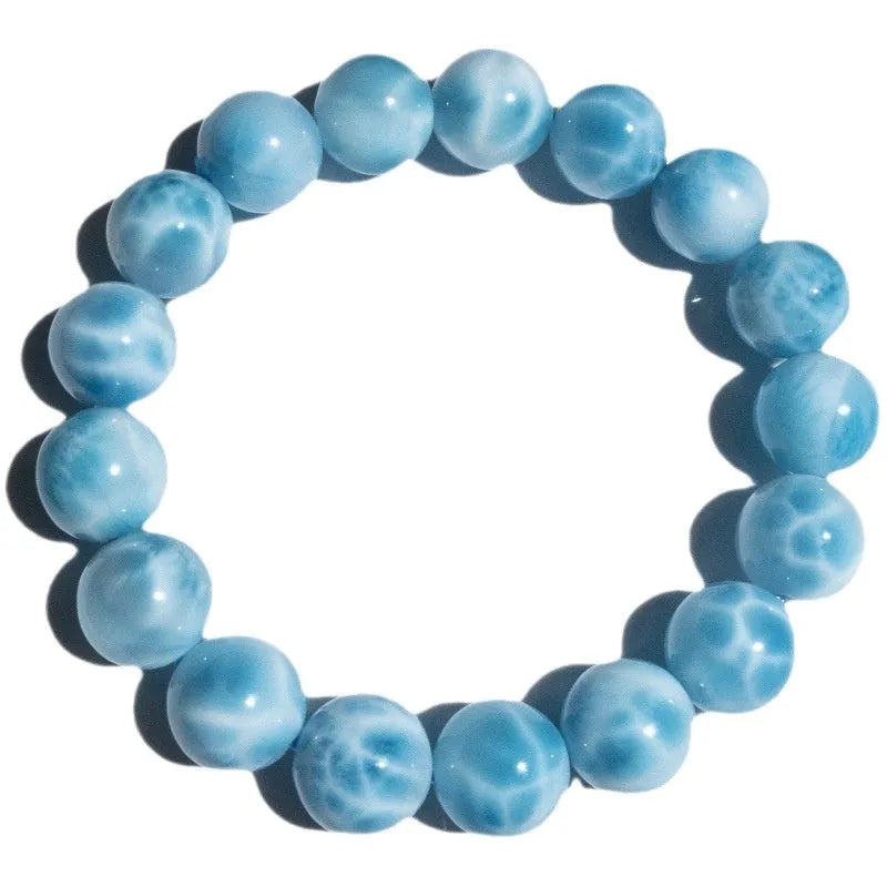 Blue handmade Bodhi bracelet with sea-pattern crystal stone and pearl accent in Maillard style.
