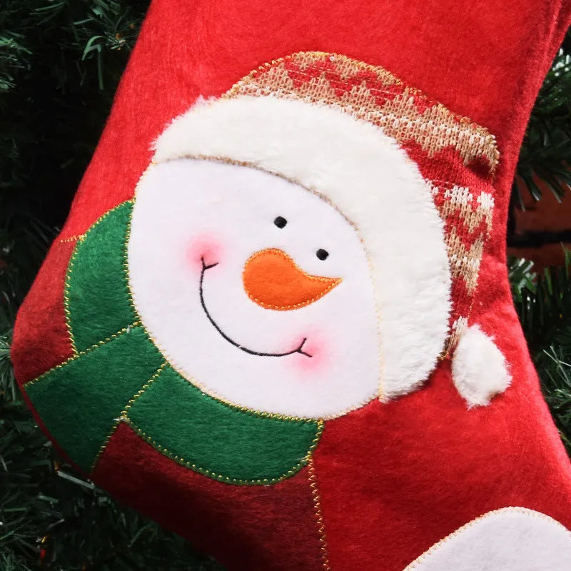 Three Christmas stocking ornaments showing elk, elderly gentleman and snowman designs in American folk art style