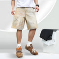 Men's light blue washed ripped straight-leg denim shorts on model front view