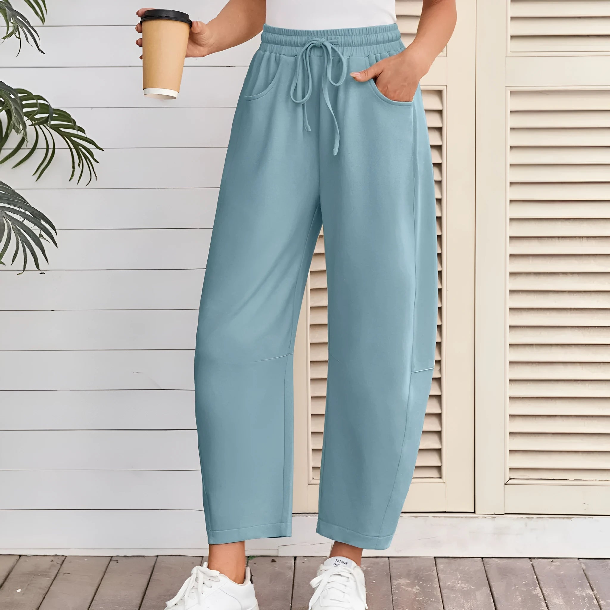 Loose cropped sweatpants with elastic drawstring waist and pockets in street fashion styling