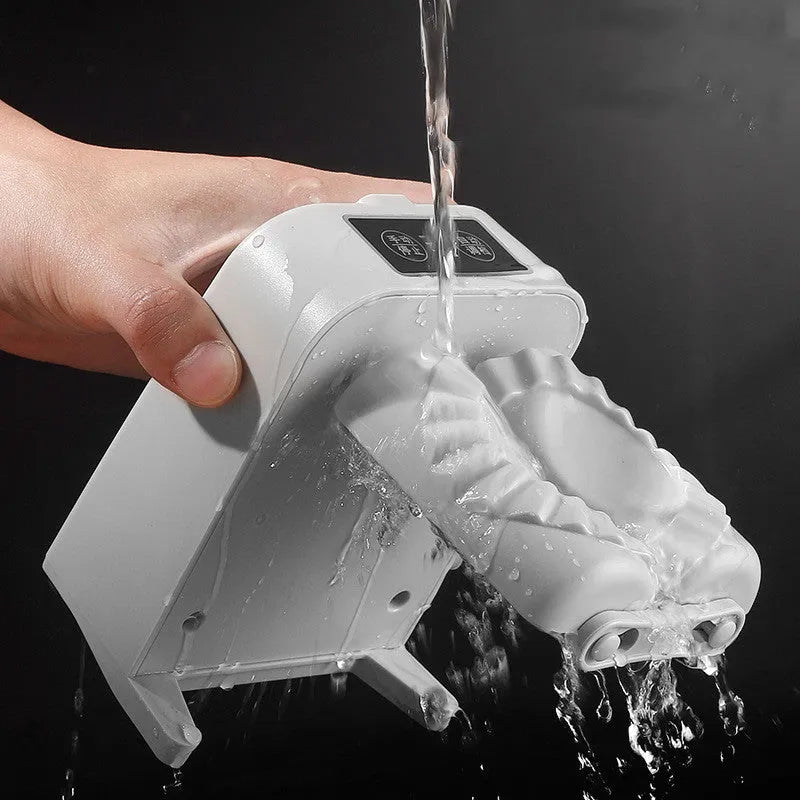 White automatic electric dumpling maker machine on a kitchen counter with USB cable and accessories
