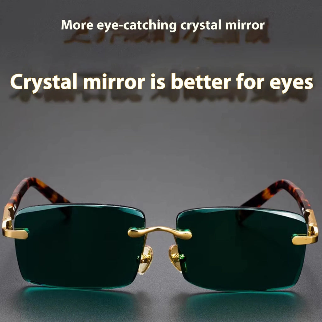 Dark green frameless crystal sunglasses with a distinctive design, shown with a hard case and lens cloth.