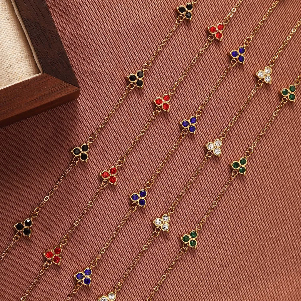 Women's stainless steel bracelet with three triangular diamond charms in geometric design with coloured stones