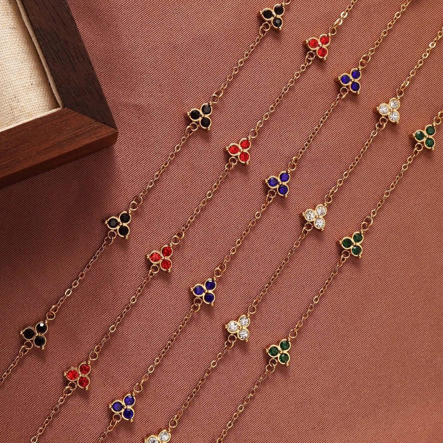 Women's stainless steel bracelet with three triangular diamond charms in geometric design with coloured stones