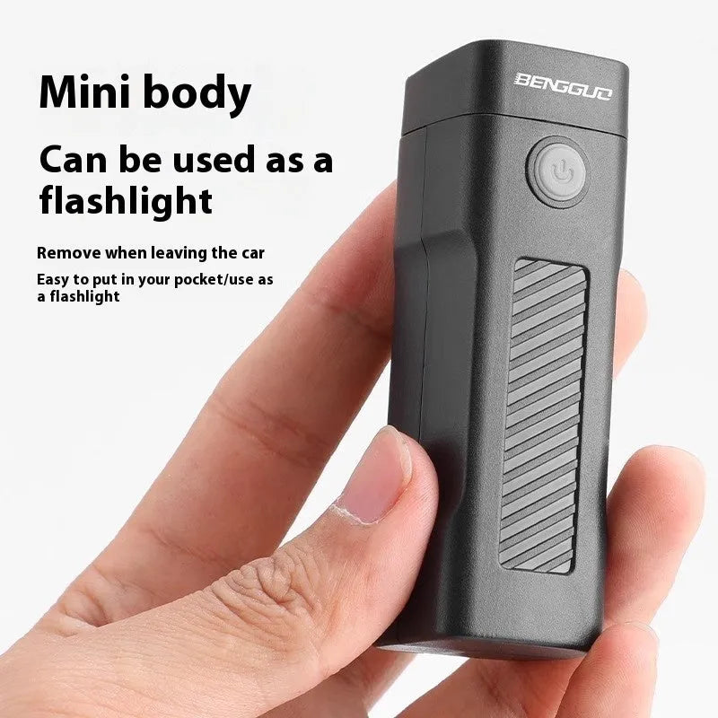 Black USB-rechargeable bicycle headlight mounted on bike handlebars with strap bracket.