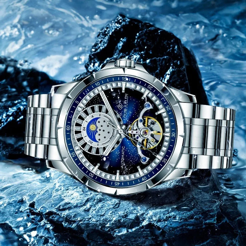 Men's silver automatic mechanical watch with blue dial and stainless steel bracelet on wrist