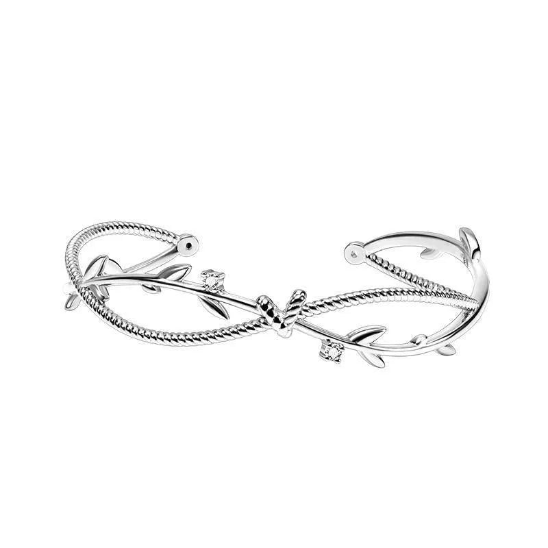 White gold copper branch sprout bracelet with twisted cross design on wrist