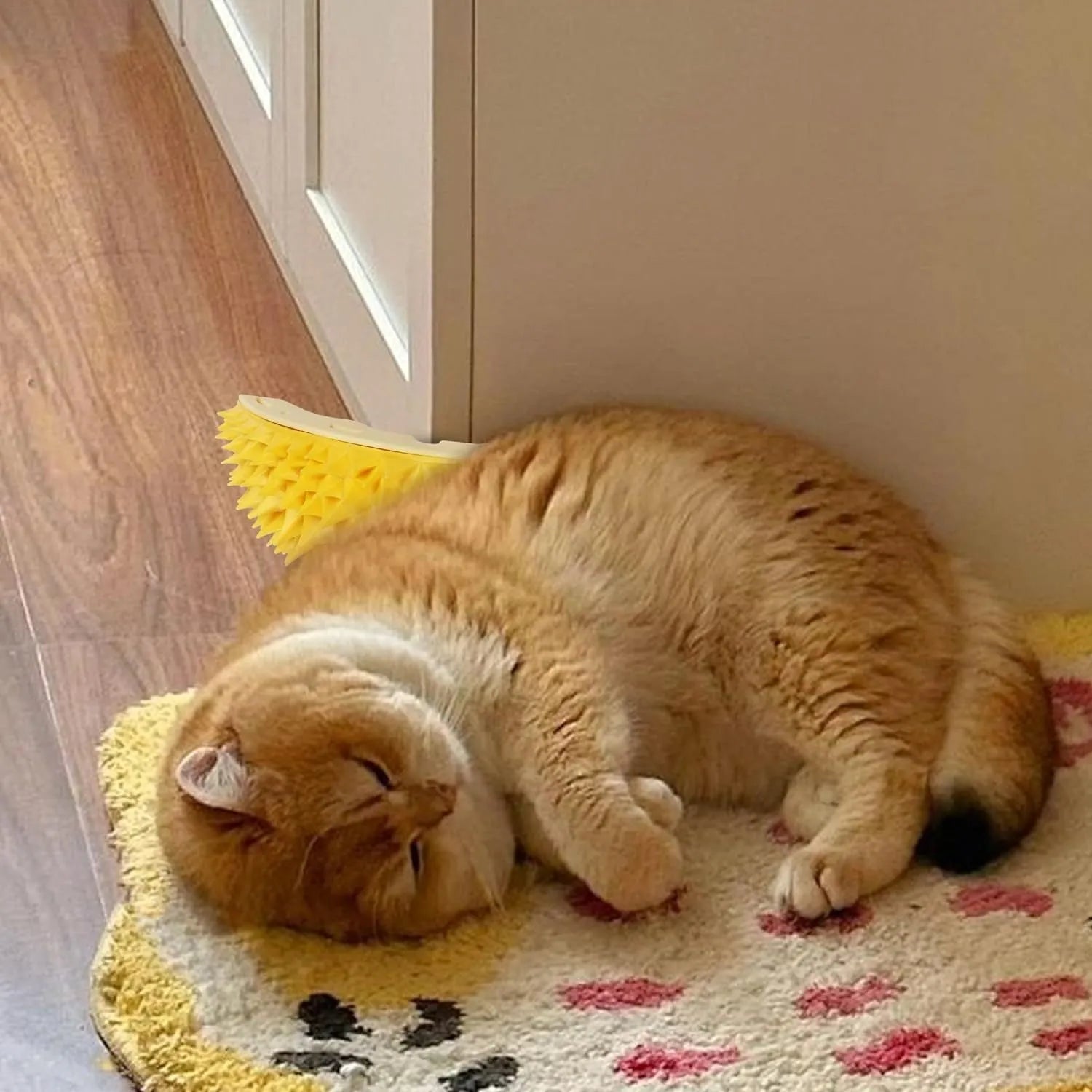 Yellow durian-shaped cat corner scratcher with cat face pattern and adhesive backing.