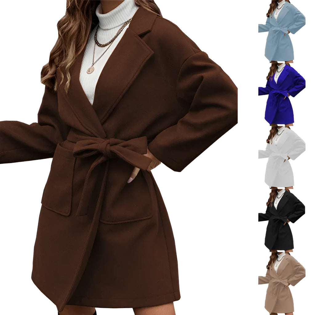 Minimalist long sleeve lapel coat with an adjustable belt and split front in a loose fit.