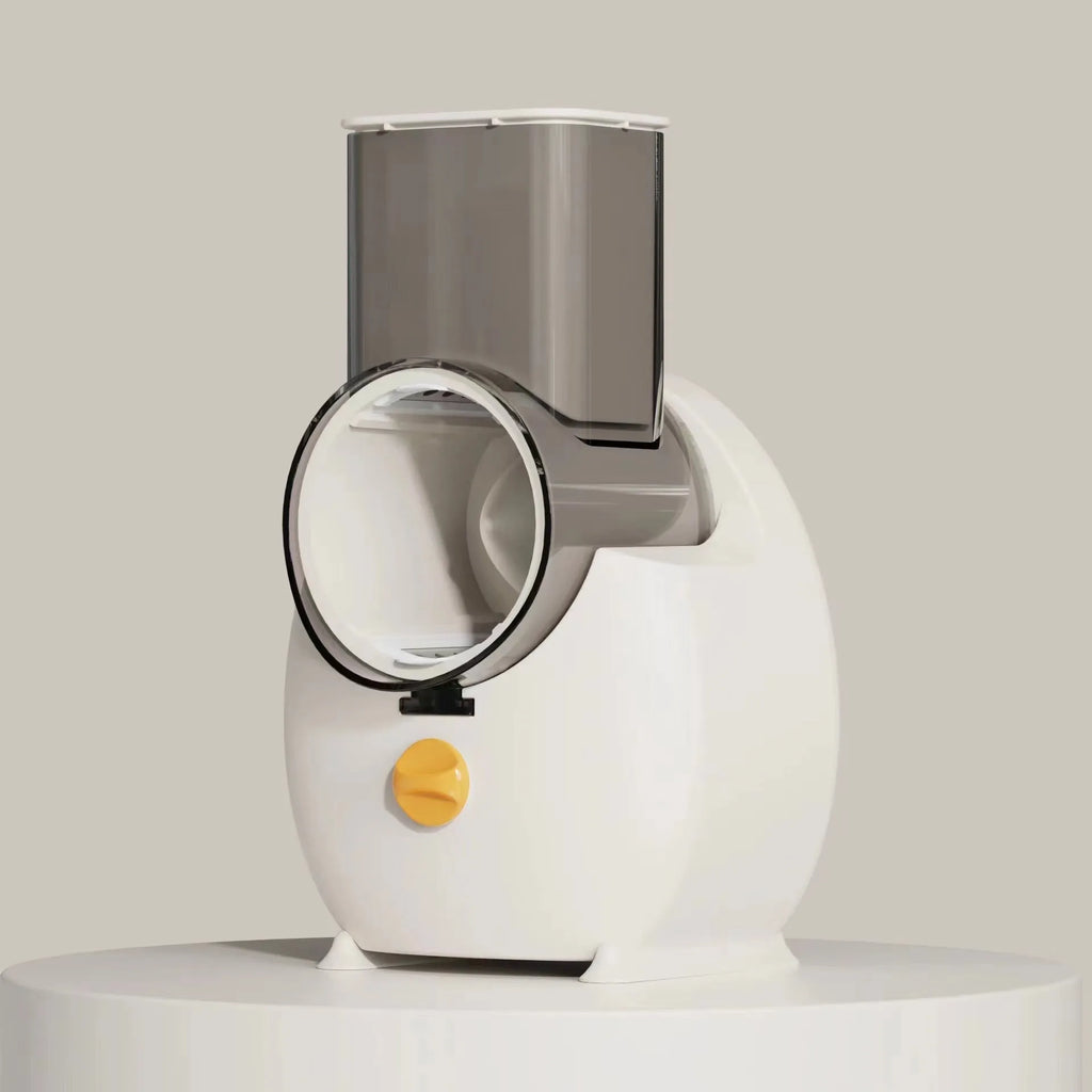 Electric vegetable slicer in white with feeding port, pressing rod, and blade barrel on a kitchen counter
