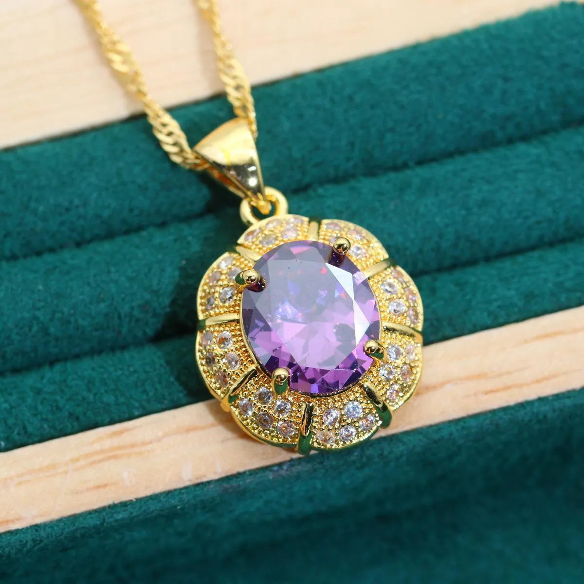 Four piece 18K gold plated jewellery set with coloured cubic zirconia stones including necklace earrings ring and bracelet