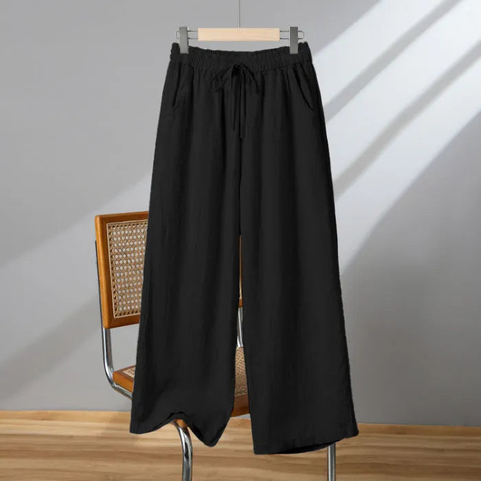Women's apricot straight-leg casual trousers with a drawstring elastic waistband laid flat.