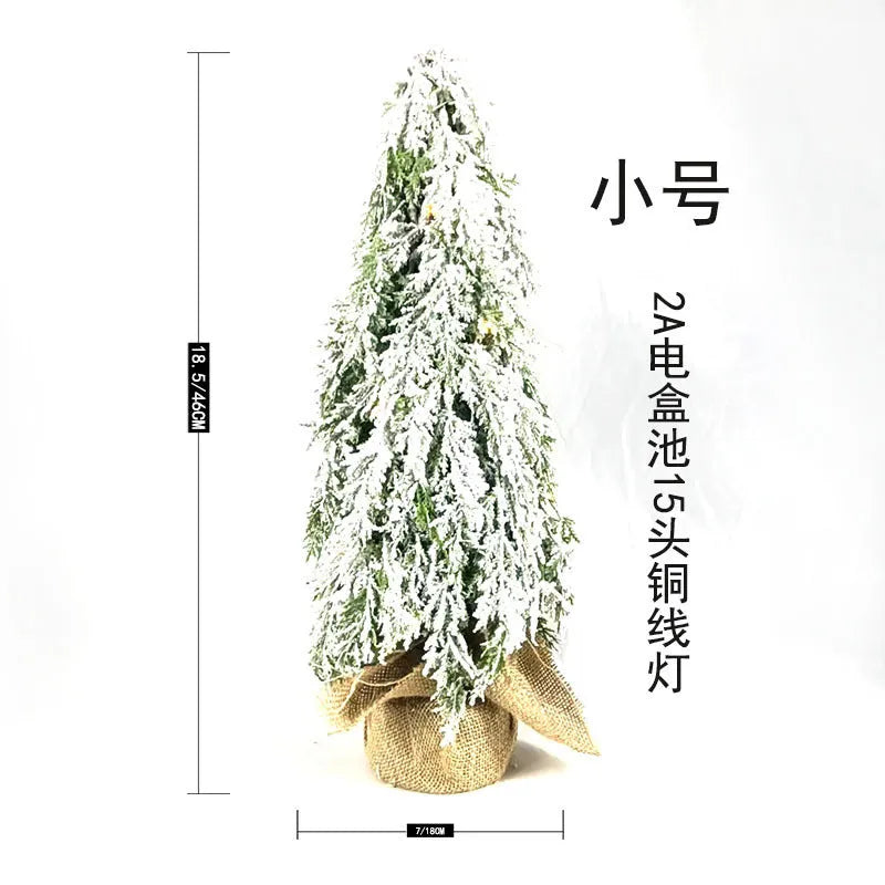 24-inch green PE plastic Christmas tree with lights and snow spray decoration on desktop