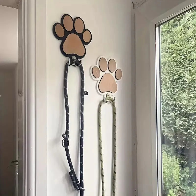 Wooden foot paw print wall hook in black finish, modern simplicity style, with a coat hanging from it
