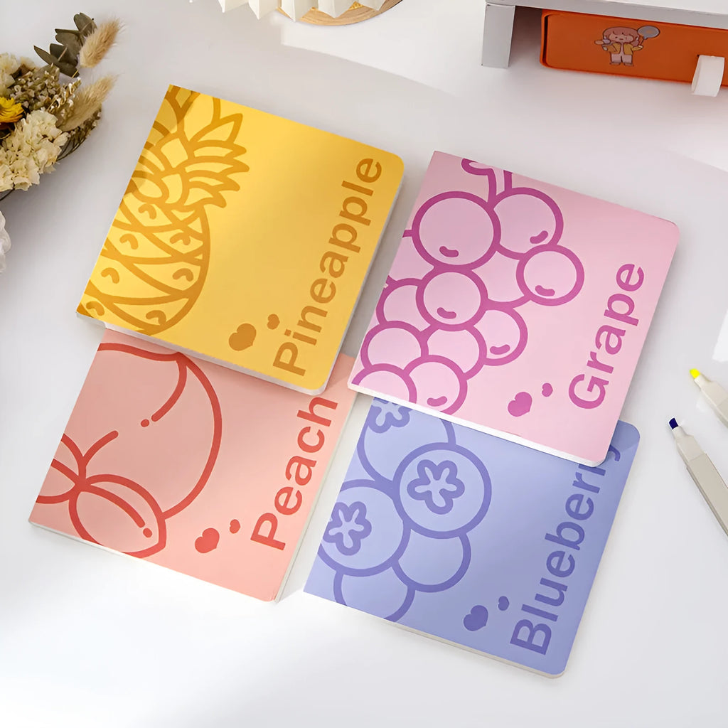 Square notebook with colourful embossed fruit cover designs, showing 14.5 cm size and thickened pages.