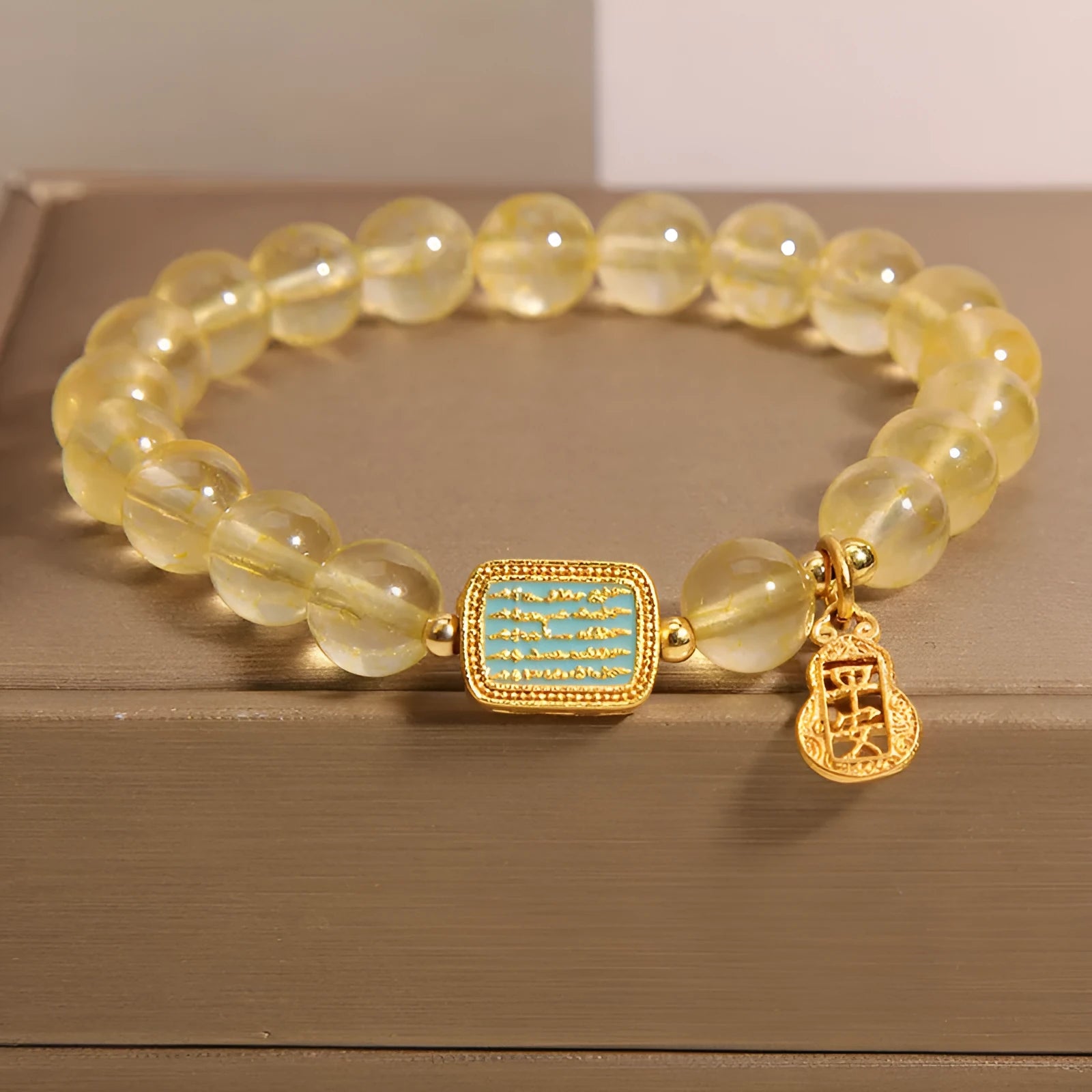 Women's natural yellow crystal bracelet with citrine colour round beads and rhinestone accents, sliding knot closure