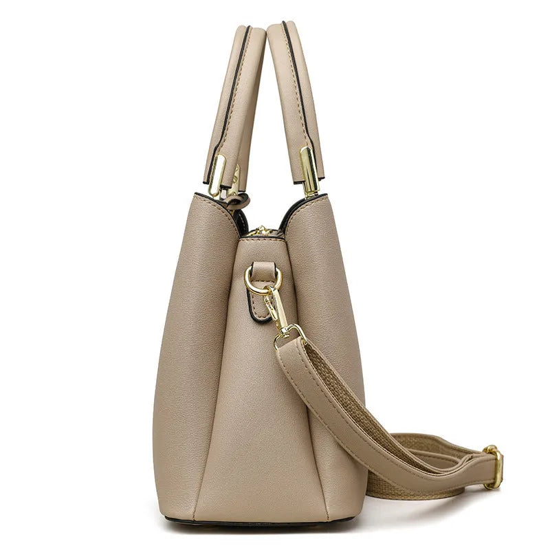 Women's black PU messenger bag with cross-body strap and multi-layer interior compartments.