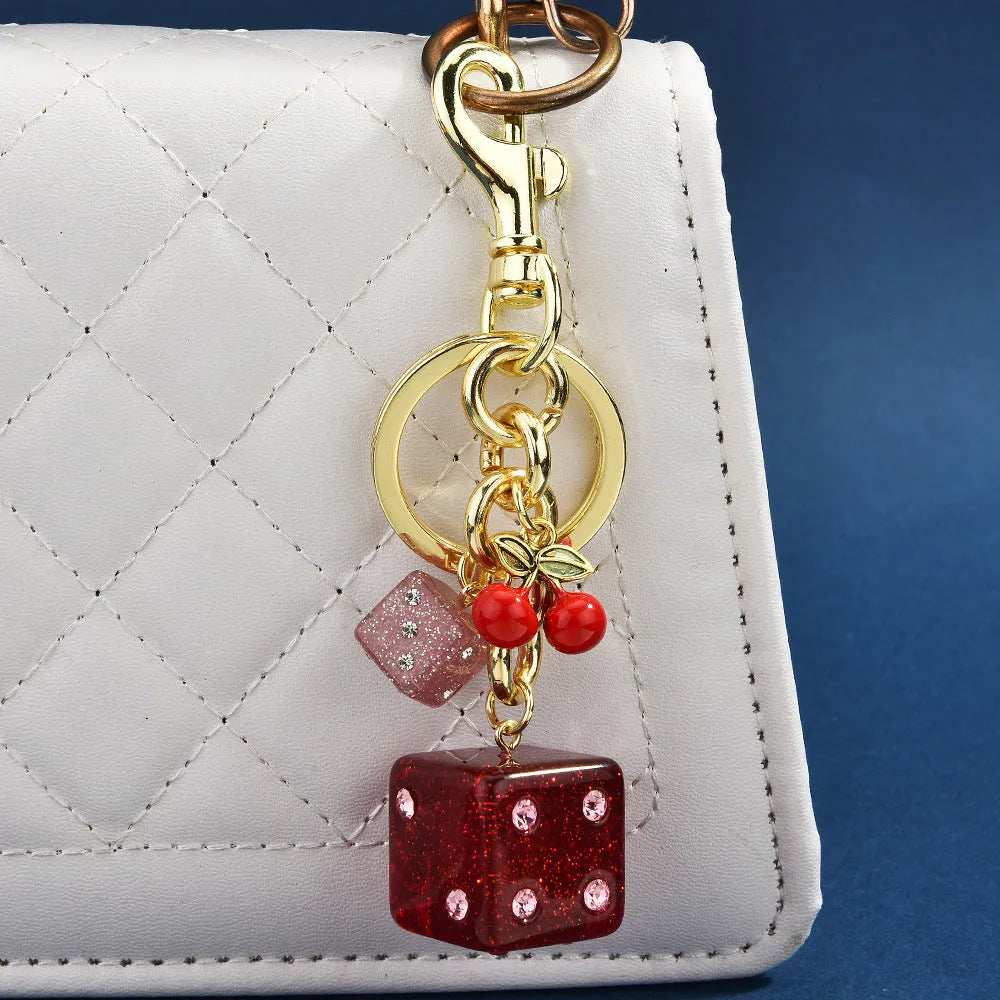 Square pattern metal keychain pendant with two-tone cherry dice design and electroplated finish