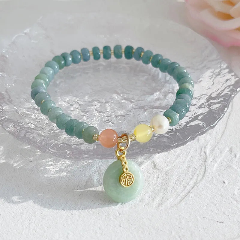 Natural blue water jade bead bracelet with gourd peace buckle design on white background