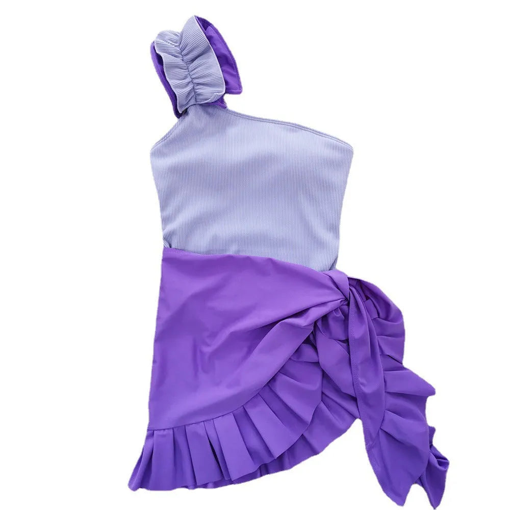 Women's single-shoulder one-piece swimsuit with a suspender strap in a solid colour.