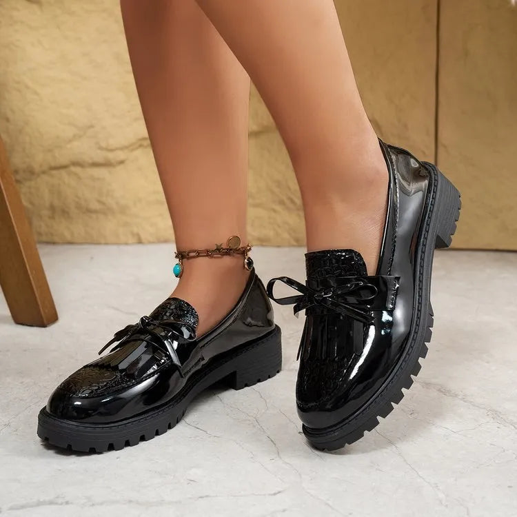Women's brown loafer shoes with decorative bow detail on synthetic PU upper