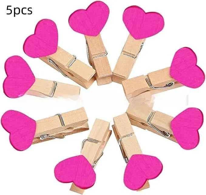Five solid wood heart-shaped clips in red colour arranged together