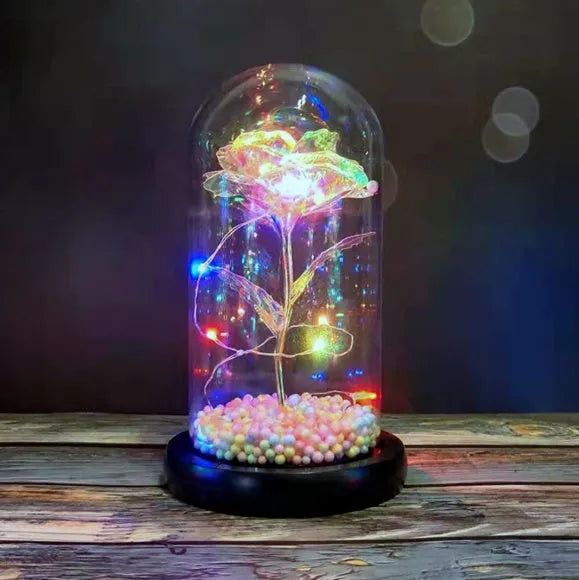 Artificial gold rose in glass flask with LED lights on black base, 20cm tall