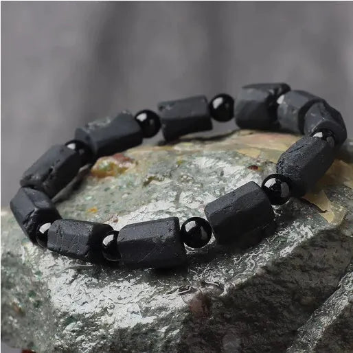 Natural black tourmaline rough stone bracelet unisex 10mm bead size on plain background