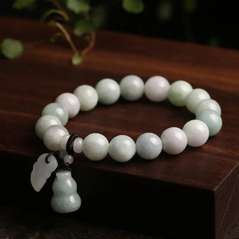 Natural jade bracelet with geometric beads showing Maitreya Buddha, double apple, and money bag symbols
