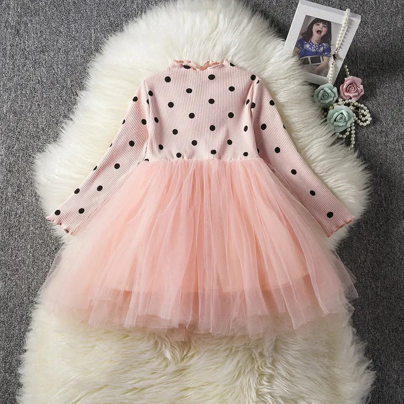 Baby girl wearing long sleeve lace tutu dress in pink for birthday party